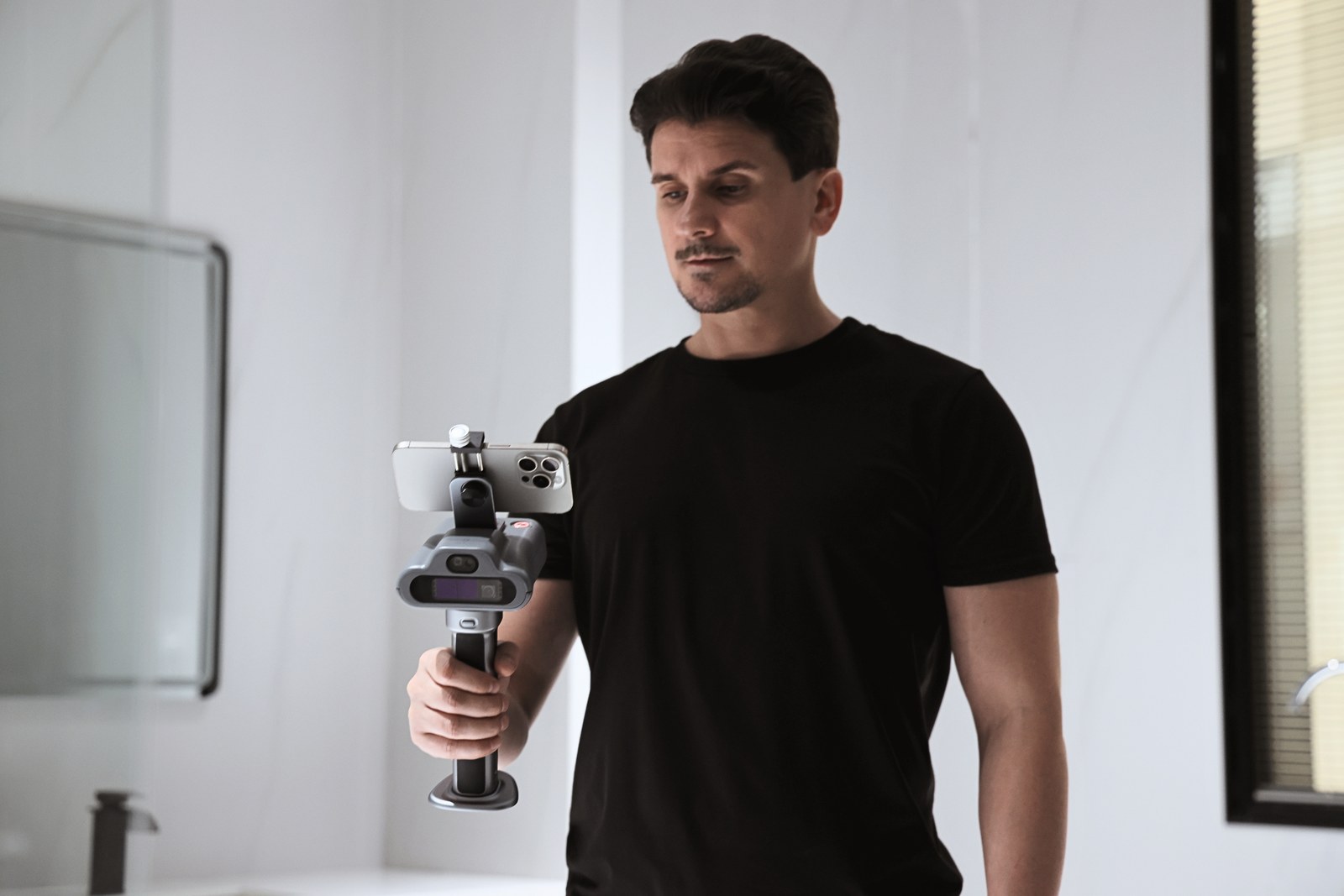 FJD Trion C1 handheld LiDAR scanner with phone in the mount